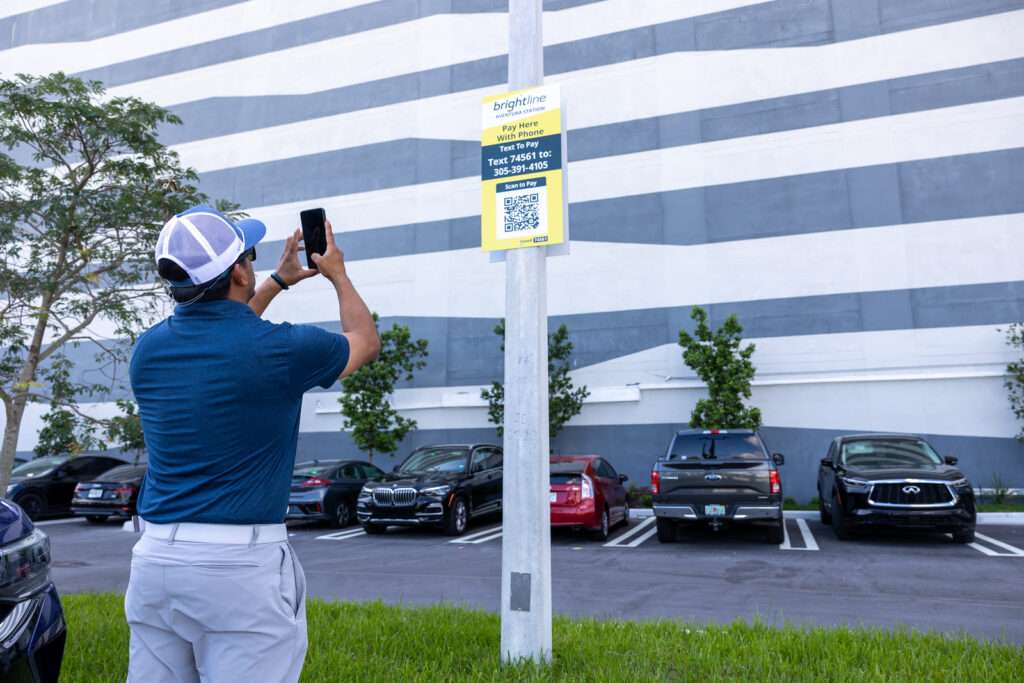 Man scanning sign in parking lot
