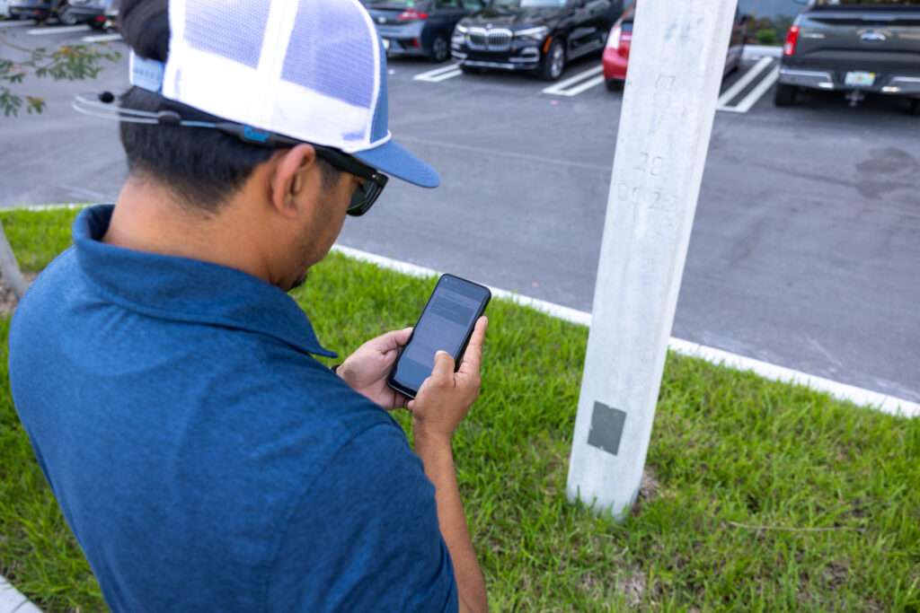 Man outside on his phone scanning QR code for text to pay